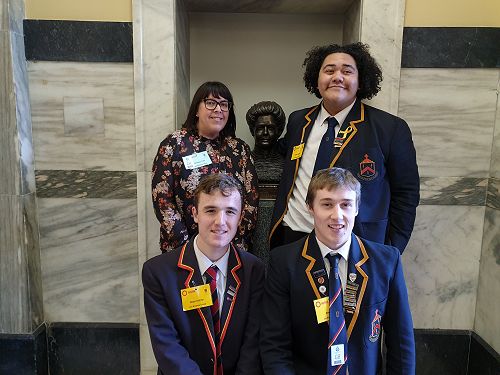 Ms Fridd, Ezekiel, Stewart, and Ben pose with Kate Sheppard in Parliament. They've recently finished a devising unit on Women's Suffrage. 
