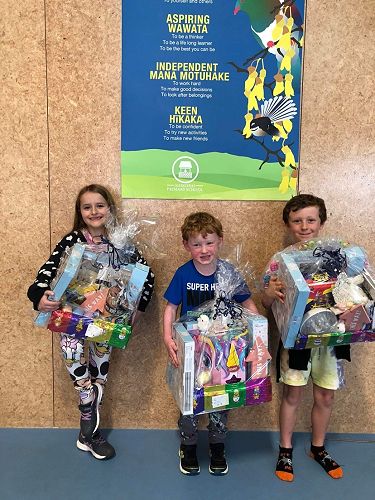 Winners of the Easter raffle, Neala, Cormac and Lia (Caio receiving it in place of his sister)