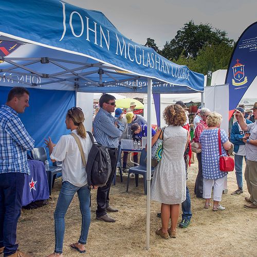 Tony Sycamore, Neil and Pam Garry chat with folks at the Wanaka A and P show.