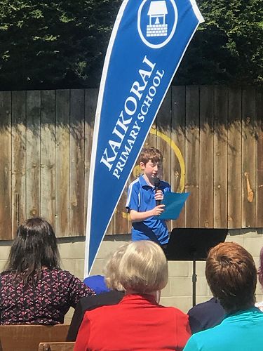 William presenting his speech at the reunion