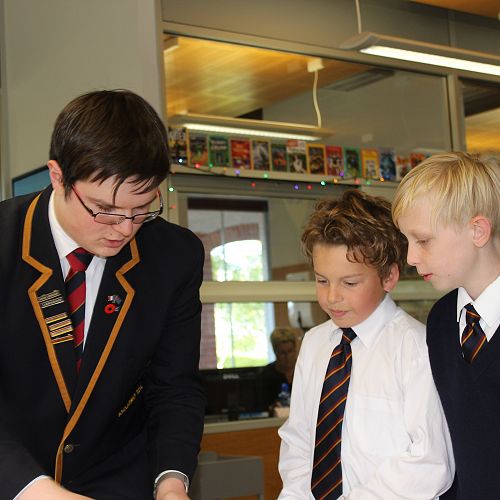 William Archer helps Zachary Smith and James Palmer with their library training.