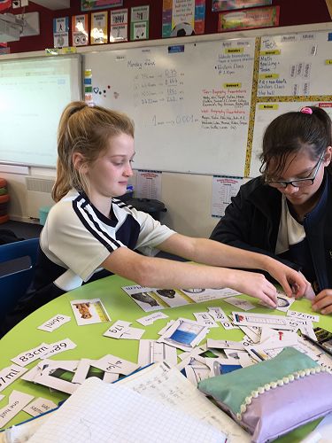 Megan and Shikaia working well together on their measurement puzzles.
