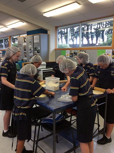 Careful concentration as students roll out their tortillas.