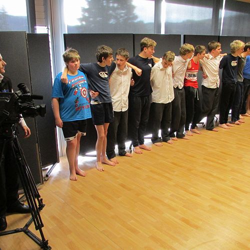 Dunedin TV Channel 39 cameraman watching the students trying out one of the RNZB's "Salute" moves from the show
