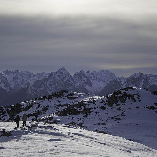 Anna Snow and Maya Berg atop the mountains. There is a rapidly advancing cold front in the distance.