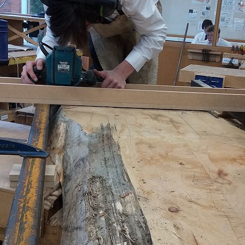 Michael Beattie using the jig he created to level out a 100 year slab of Macrocarpa.