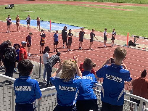 The boys ready to cheer on Levi in the hurdles final