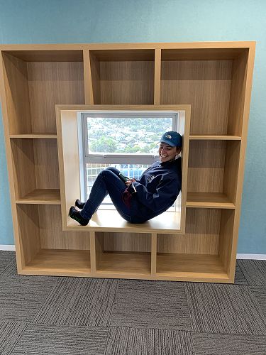 Mrs McBeath tries out the new window seat in the library