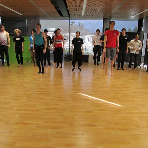 Dancer Loughlan, Educator Pagan, and dancer William (all of the RNZB), show the class a movement to try