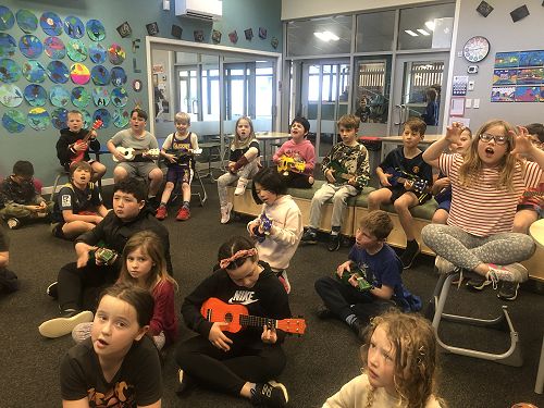 R9 having a go with the ukulele