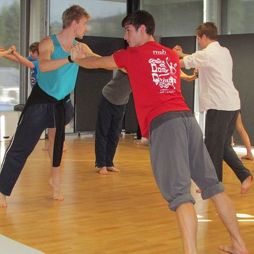 RNZB dancers Loughlan and William look on to check how the students are coping with the counterbalance exercises