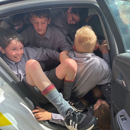 Year 7s pile out of the car after breaking the record.