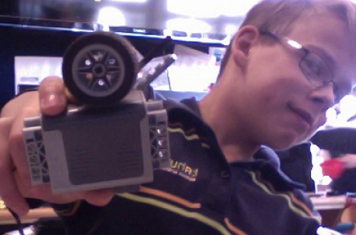 Conner with his Lego 9volt battery pack (Energy Source) and the wheels he selected for his car.