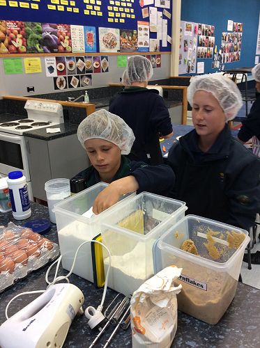 Angus concentrating on measuring his ingredients carefully.