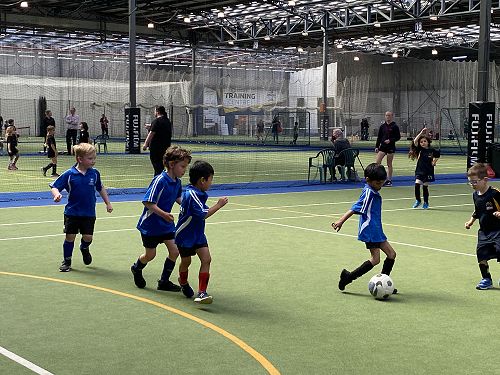 Bodhi, Conner, Max and Nisal chase the ball at futsal