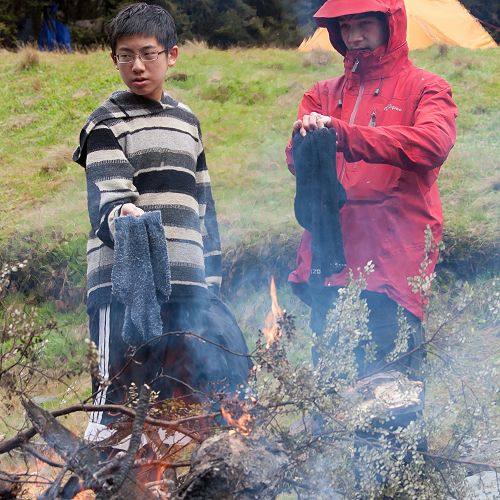 Boen Deng and Ben Wishart dry their socks after a snowy days walk.