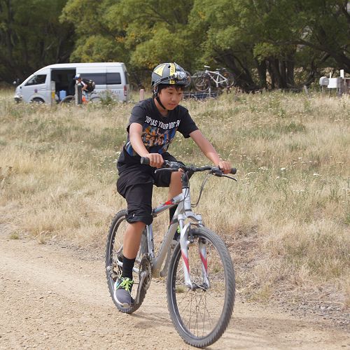 Aidan Hung biking confidently through the Ida Valley
