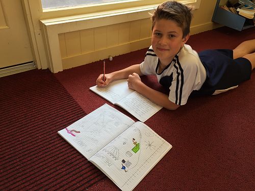 Spencer Campbell working on his writing in the library