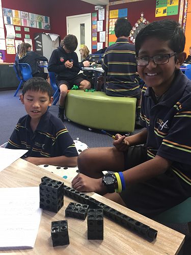 Ashton and Nimesh exploring volume with blocks.