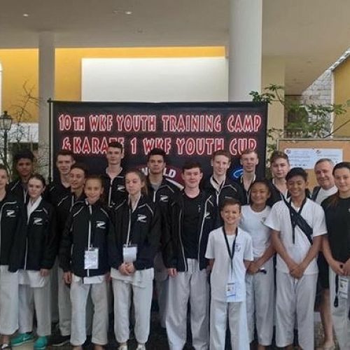 Whole group photo in the hotel lobby.