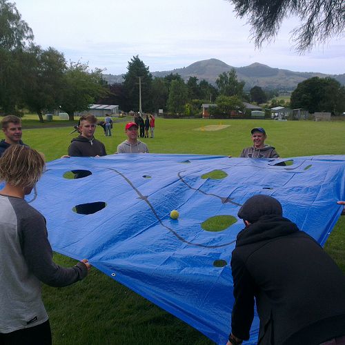 Playing "A-maze-balls". The boys working together.