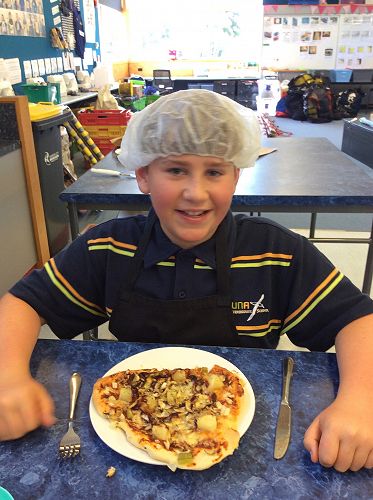 Rocko proudly displaying his pizza creation