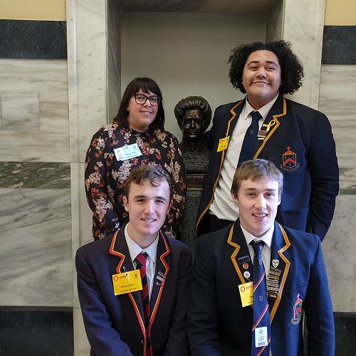 Ms Fridd, Ezekiel, Stewart, and Ben pose with Kate Sheppard in Parliament. They've recently finished a devising unit on Women's Suffrage.&nbsp;