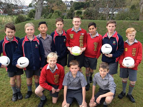 Members of the 2015 Balmacewen Boys Football team pose to show off the new training balls for the season