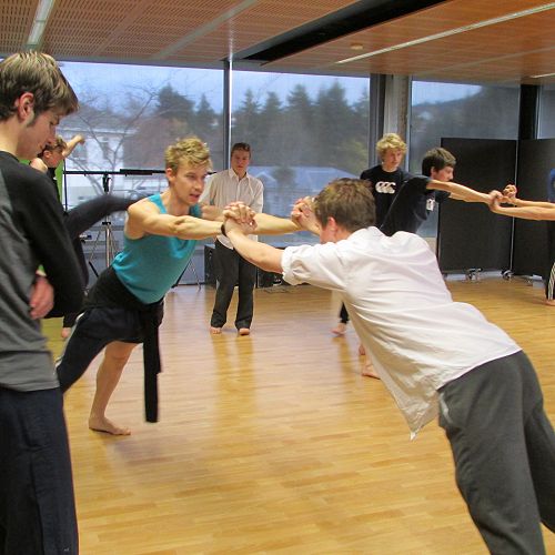 Jacob Walker watches RNZB dancer Louglan and senior drama student Alfie, try one of the counterbalance exercises