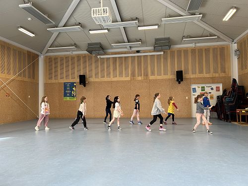 Year 3-4 Jump Jam team practising in front of the Jump Jam super star Brett Fairweather