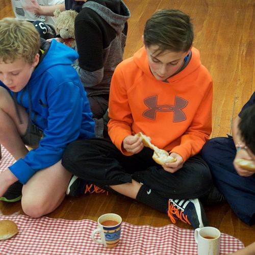 Caleb, Miro and Flook sit down for their 'soup and bun' meal