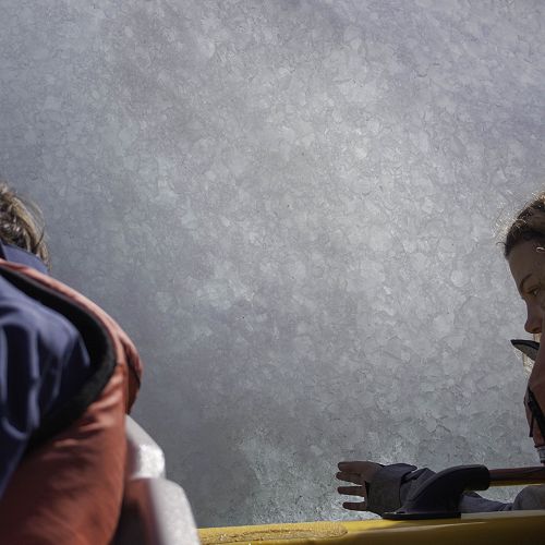 Anna Snow reaches out to an iceberg on Lake Tasman.