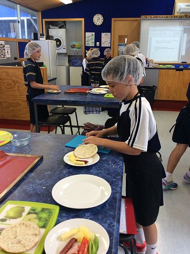 Year 7 students begin constructing their own pizzas.