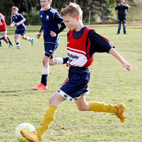 Grayson Westgate clears the ball up-field in the Waihi Exchange Football Game.&nbsp;