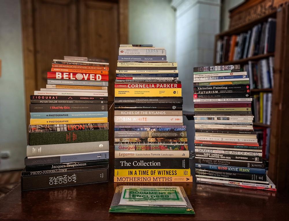 Can you spot a little touch of Ōtepoti in this stack of books from all over the globe?