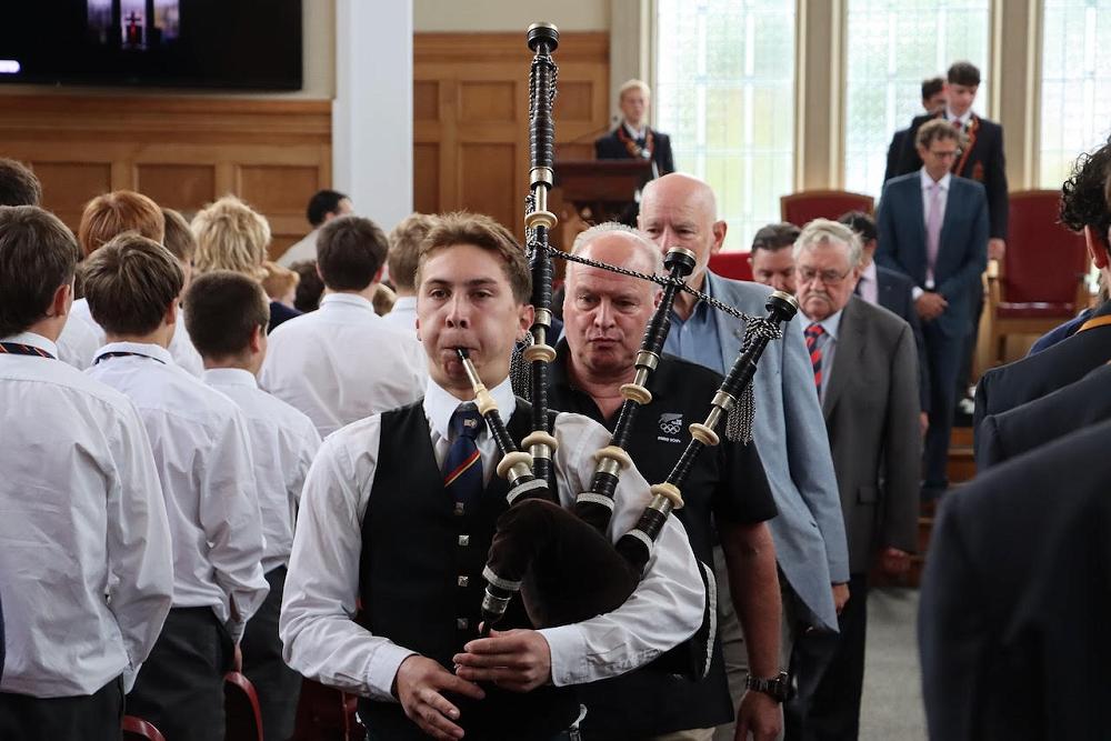 Distinguished Old Collegians Lars Humer & Colin Brown follow piper Caleb Ung up the aisle.