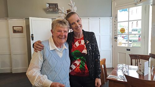 Carmel (manager) giving Hazel her five year volunteer a celebration