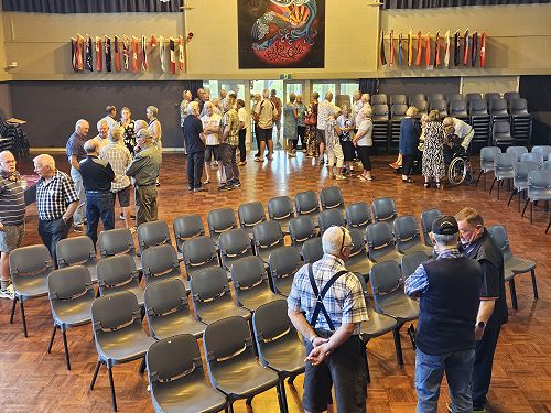 Former classmates gathering in the school hall