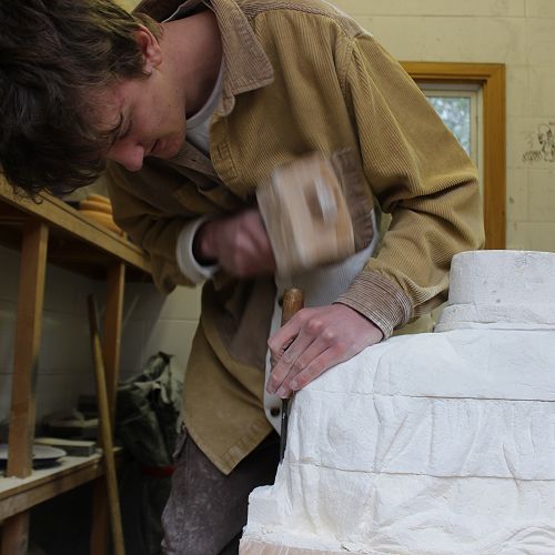 James hard at work with the hammer and chisel