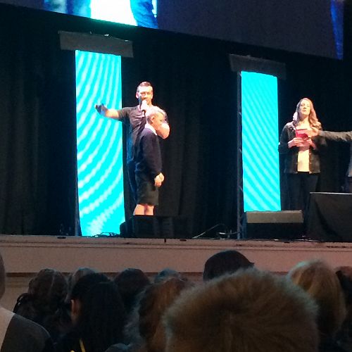 Hunter Cockerill heading onstage to present Aaron Jackson with a Koha