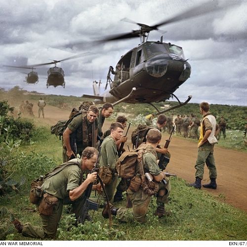 Australian soldiers waiting to be airlifted by Iroquois helicopters; Vietnam War, c. late 1960s.