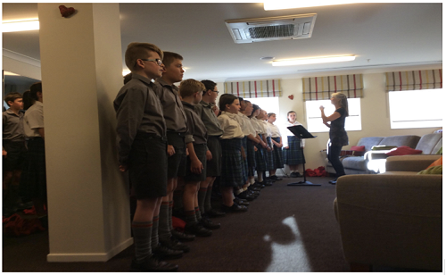 The choir singing 1914 to the residents of summerset.