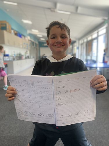 Noah proudly shows us his printing